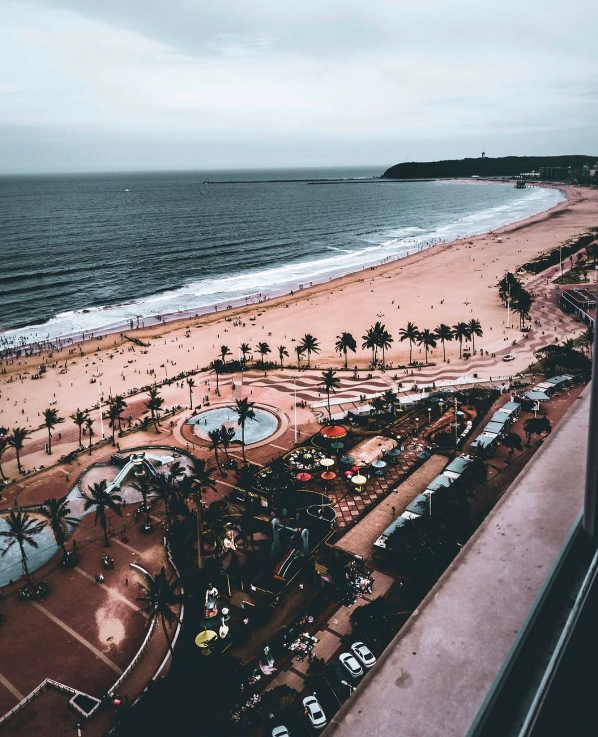 Beachfront and promenade seen from above, with the coastline curving to the horizon