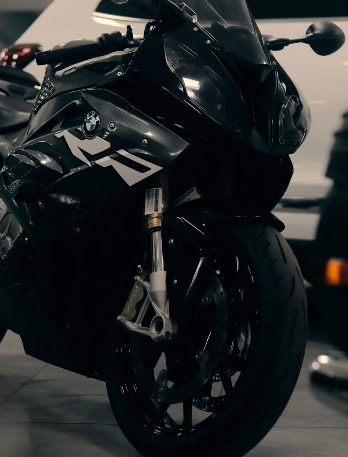 Front fairing and wheel of a black sports motorcycle