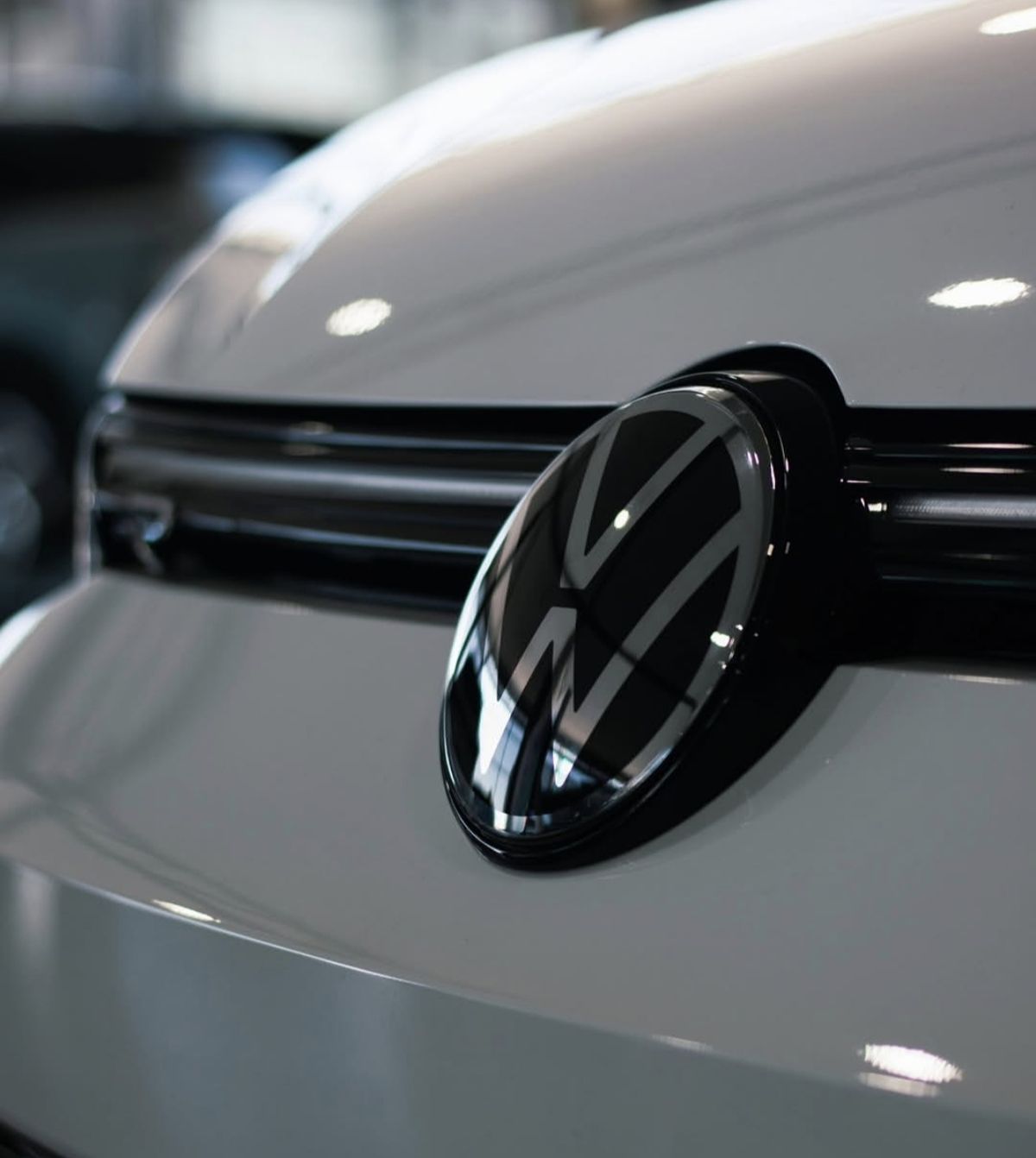Close-up of the front badge on a white hatchback