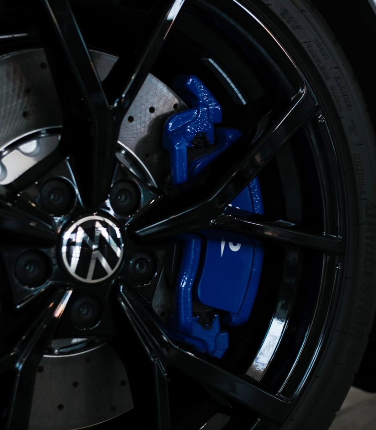 Black alloy wheel with a blue brake caliper