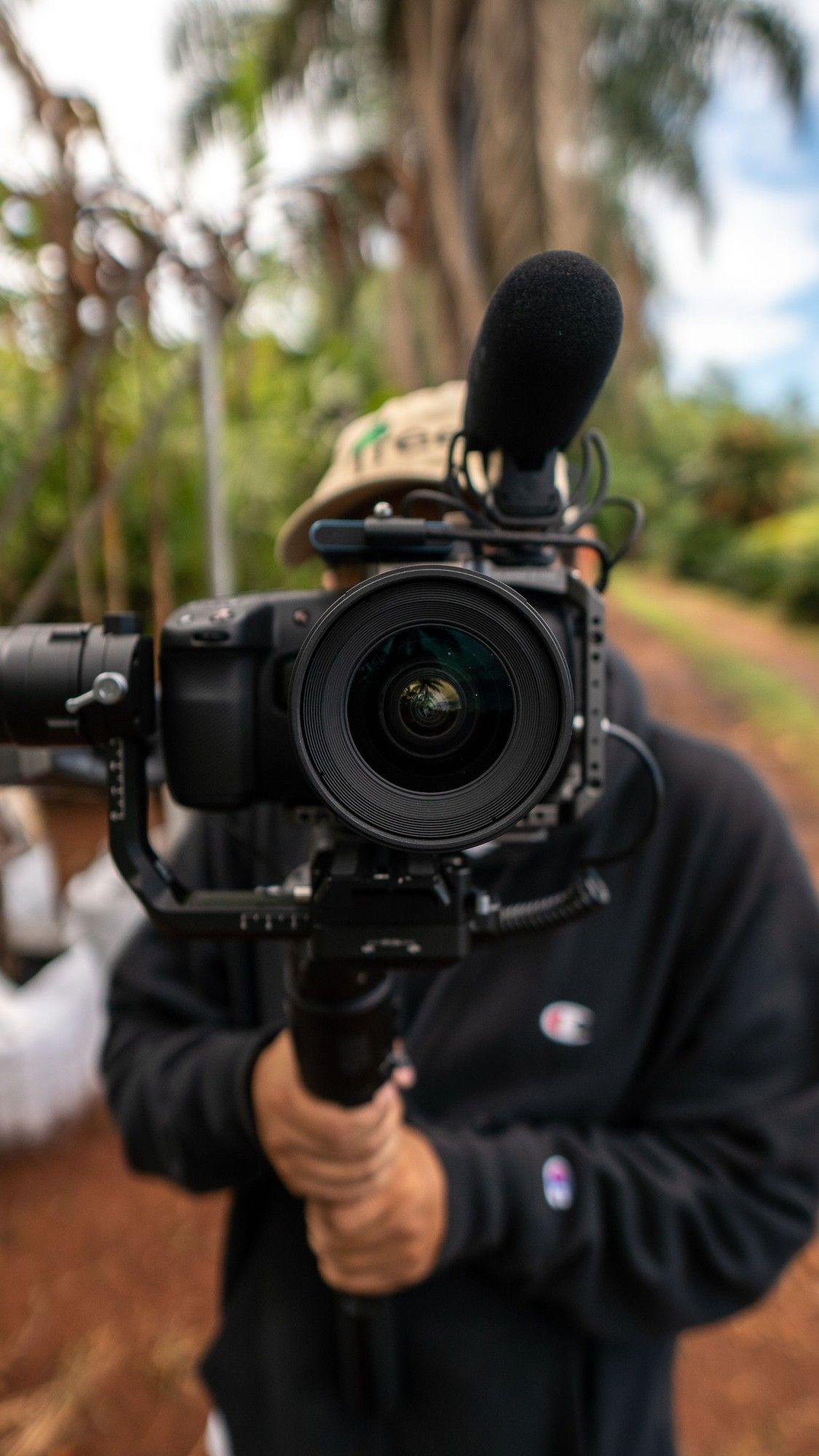 Videographer filming outdoors with a camera on a gimbal